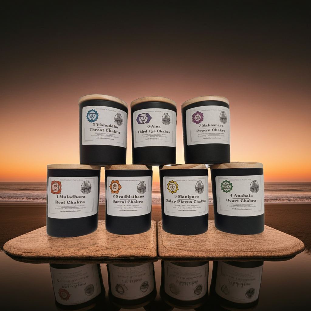 Set of candles with labels on a wooden stand against a sunset beach Chakra candle set by Luz del Mar Candles
background
