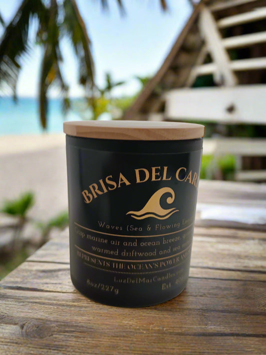 brisa-del-caribe-ocean-breeze-candle set on a rail at a beach house over looking the ocean.